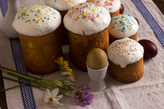 Olive Easter egg and pascaline bread on a table with flowers. Easter concept, background