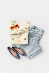 Fashion spring outfit. White jumper with blue jeans and ballet shoes. Women's stylish and elegant...