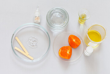 Top view of moisturizing anti-aging vitamin cosmetic gel with citrus extracts in a Petri dish on a laboratory table. Development of new types of organic cosmetics concept. Flat lay, close-up