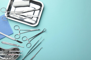 Different surgical tools on turquoise background, flat lay. Space for text