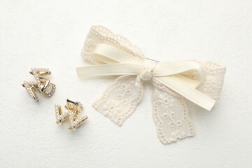 Hair bow and clips on white table, flat lay