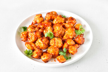 Sweet chili cauliflower wings on white plate