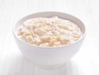 Oatmeal porridge in white bowl.