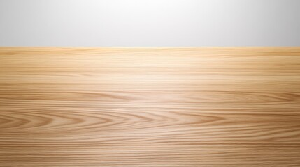 Fototapeta premium A smooth wooden surface illuminated by soft lighting, showcasing its natural grain and texture against a light backdrop.