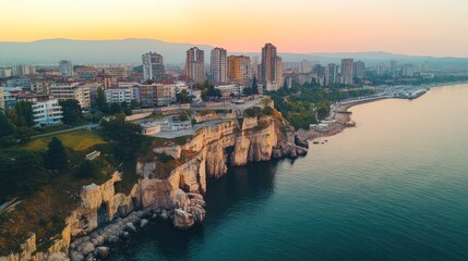 Fototapeta premium Coastal city at sunrise, aerial view.