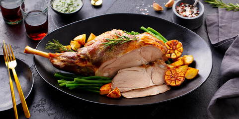 Roasted lamb leg with green bean and red wine. Grey background. Close up. © annapustynnikova