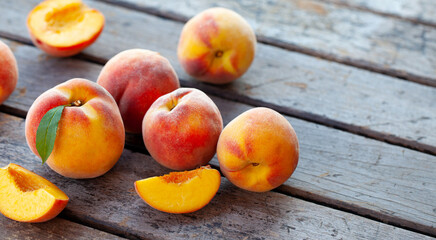 Fresh peaches on grey wooden background. Close up. Copy space.