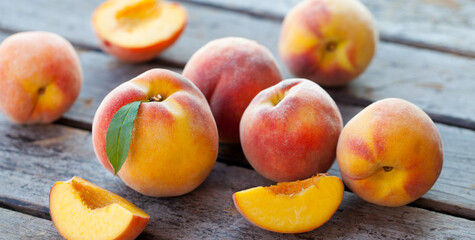 Fresh peaches on grey wooden background. Close up.