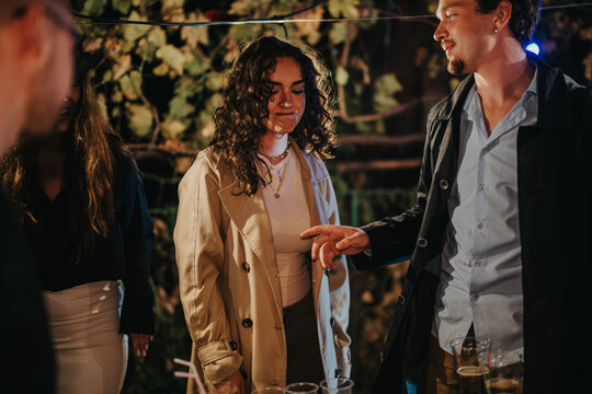 An outdoor gathering of friends enjoying moments together in a warm and inviting atmosphere, showcasing camaraderie and enjoyment during a special occasion or casual celebration.