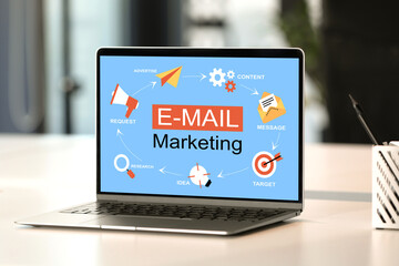 Email marketing website page on laptop screen. Workplace with computer on table