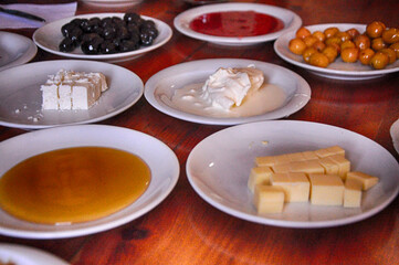 Turkish breakfast. Honey, olives, tomatoes, breads, jam, cheese, clotted cream