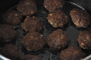 Meatball frying in pan. Turkish kofte