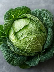 Obraz premium Fresh savoy cabbage on gray background, close up of vibrant green head