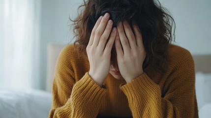 Emotional distress experienced by a person sitting in a cozy room with soft natural light, highlighting feelings of sadness and solitude