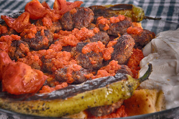 Meatballs (kofta) with yogurt, tomato sauce and pide (pita).