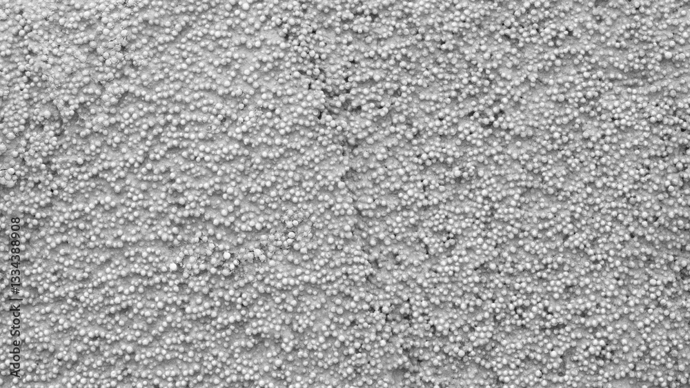 Aufkleber a grey background with white dots. the dots are small and scattered. the background is not very deta