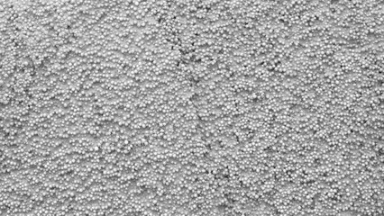 A grey background with white dots. The dots are small and scattered. The background is not very detailed