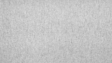 White fabric with a pattern of small squares as a textured background. All the squares are different sizes and are arranged randomly