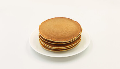 Pancakes for breakfast on a white background.