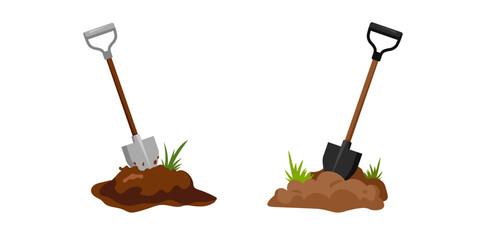Two shovels are in soil with grass, highlighting tools used for gardening and outdoor tasks. © Богдан Скрипник