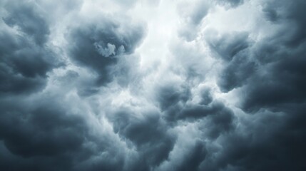 Obraz premium Dramatic stormy sky, dark ominous clouds swirling in turbulent patterns, evoking a sense of impending weather change.