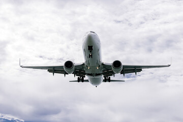 An airplane glides across a bright blue sky. The concept of air travel and travel.