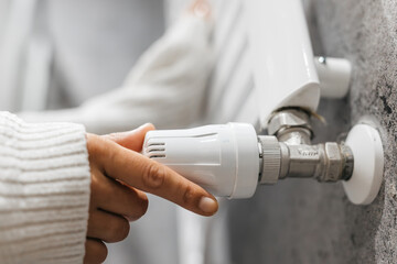 Temperature regulator on the radiator. A concept emphasizing energy saving, heating systems and home comfort. Ideal for energy efficient housing and winter home solutions.