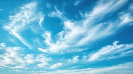 Fototapeta premium Dreamy sky with delicate white clouds drifting across a deep blue expanse, perfect for a natural backdrop.