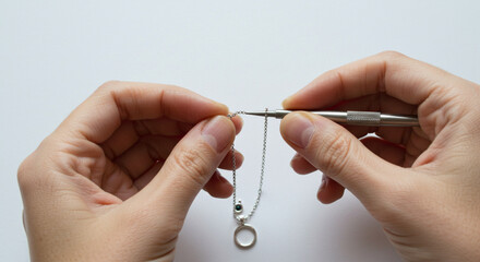 Person working on silver chain creation