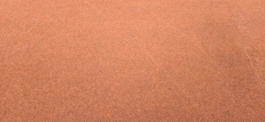 Brown carpeted floor. Velvet floor, orange-brown fabric background. Image of brown soft leather. monochrome brown carpet 

