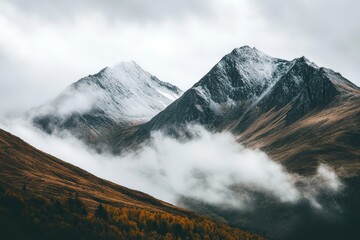 Misty Mountain Range With Clouds Gracefully Drifting Through the Peaks Creating an Ethereal Landscape at Dawn