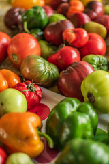 Colourful assortment of tomatoes and peppers on a table.