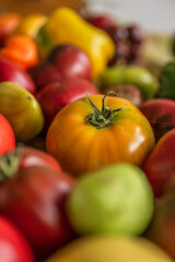Colourful assortment of tomatoes and peppers on a table.