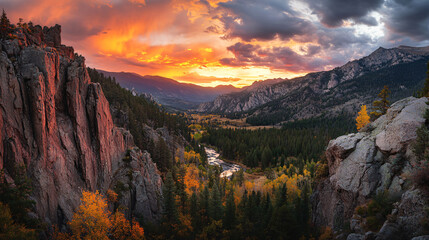 Naklejka premium breathtaking sunset illuminates Rocky Mountains, casting vibrant hues over rugged cliffs and dense forest, with serene river winding through valley