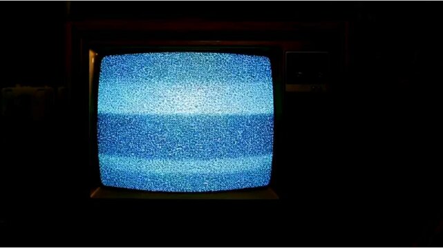 A vintage television screen displaying static noise, evoking nostalgia and mystery. Perfect for themes of analog technology, lost signals, or eerie horror aesthetics.