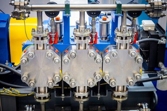 In the industrial fluid processing industry, a high-pressure triplex pump system with stainless steel components, bolted covers, and hydraulic connections is shown