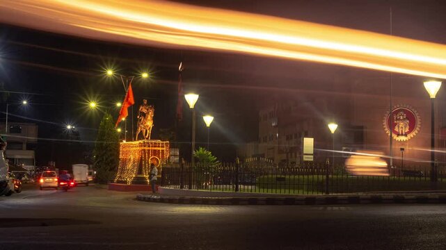 4k Hyperapse Timelapse Night footage of Mapusa City in Goa with traffic light trails of vehicles and statue of Shivaji Maharaj