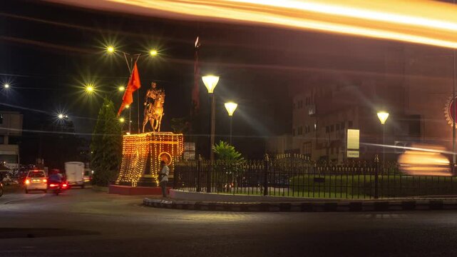 4k Hyperapse Timelapse Night footage of Mapusa City in Goa with traffic light trails of vehicles and statue of Shivaji Maharaj