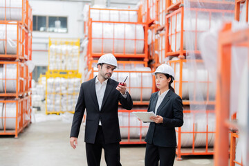 As AI transformed the industry, a European male company owner partnered with an Asian female engineer to implement smart machinery that streamlined the industrial plant’s business processes.