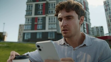 Frustrated Caucasian man reading bad news mobile phone smartphone cellphone male businessman stressed nervous guy city message error connection problem worried business outdoors holding cup coffee app