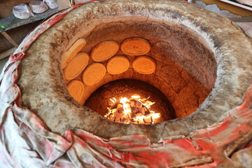 Baking bread in a tandoor oven in Kazakhstan.