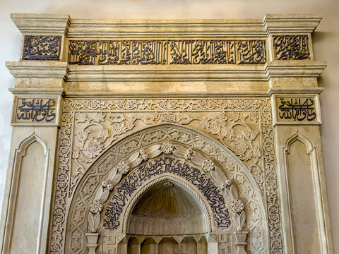 Famous Beyler mosque - Cordoba like mosque in Baku Azerbaijan built in 1894-1895, view of the minbar (pulpit) with text translation: In the name of god, most merciful and bountiful, and patron names.