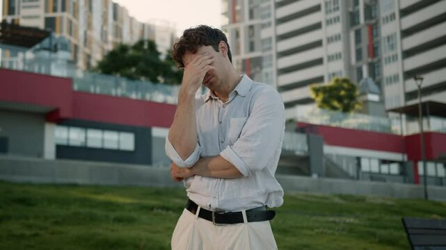 Sad Caucasian man problem crisis job loss feel pain despair male guy businessman city frustrated depressed headache stress worried upset employer student work bankruptcy health tired outdoors business