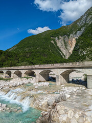 Soca Valley, Slovenia &ndash; Aerial view of the emerald-green Alpine River Soca on a bright sunny summer day with green foliage..The last wild river in Europe in Triglav National Park near the Vricic Pass