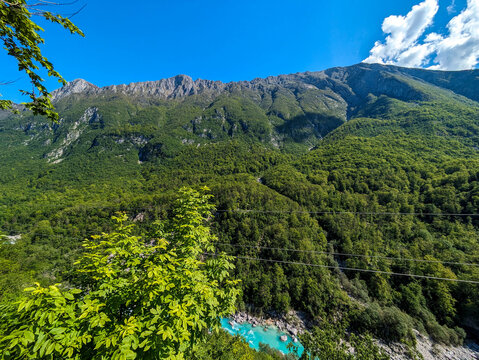Soca Valley, Slovenia &ndash; Aerial view of the emerald-green Alpine River Soca on a bright sunny summer day with green foliage..The last wild river in Europe in Triglav National Park near the Vricic Pass