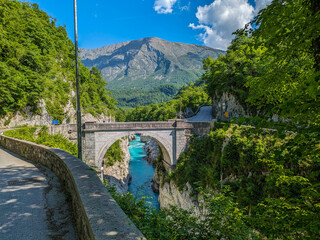 Soca Valley, Slovenia &ndash; Aerial view of the emerald-green Alpine River Soca on a bright sunny summer day with green foliage..The last wild river in Europe in Triglav National Park near the Vricic Pass