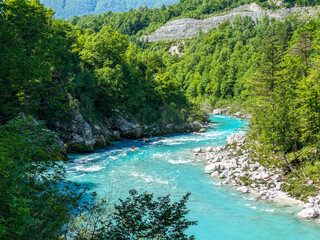 Soca Valley, Slovenia &ndash; Aerial view of the emerald-green Alpine River Soca on a bright sunny summer day with green foliage..The last wild river in Europe in Triglav National Park near the Vricic Pass