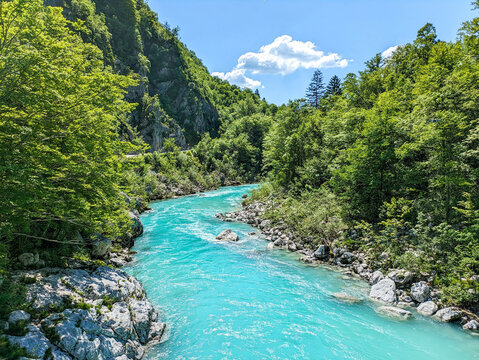Soca Valley, Slovenia &ndash; Aerial view of the emerald-green Alpine River Soca on a bright sunny summer day with green foliage..The last wild river in Europe in Triglav National Park near the Vricic Pass