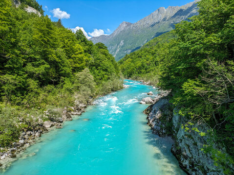 Soca Valley, Slovenia &ndash; Aerial view of the emerald-green Alpine River Soca on a bright sunny summer day with green foliage..The last wild river in Europe in Triglav National Park near the Vricic Pass
