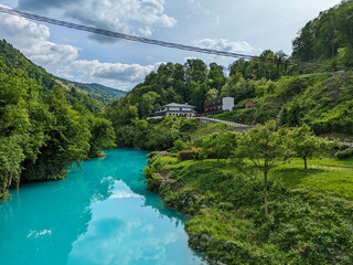 Soca Valley, Slovenia &ndash; Aerial view of the emerald-green Alpine River Soca on a bright sunny summer day with green foliage..The last wild river in Europe in Triglav National Park near the Vricic Pass
